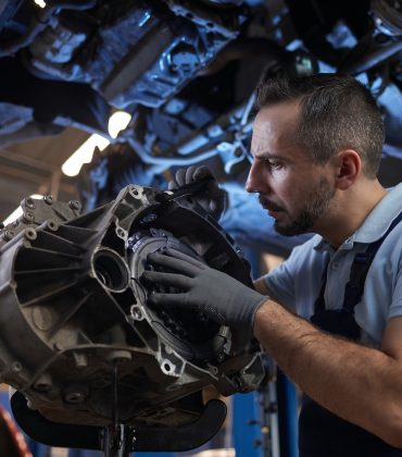 Auto Mechanic Fixing Car on Lift